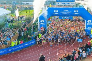 The starting line of a marathon with people beginning to run