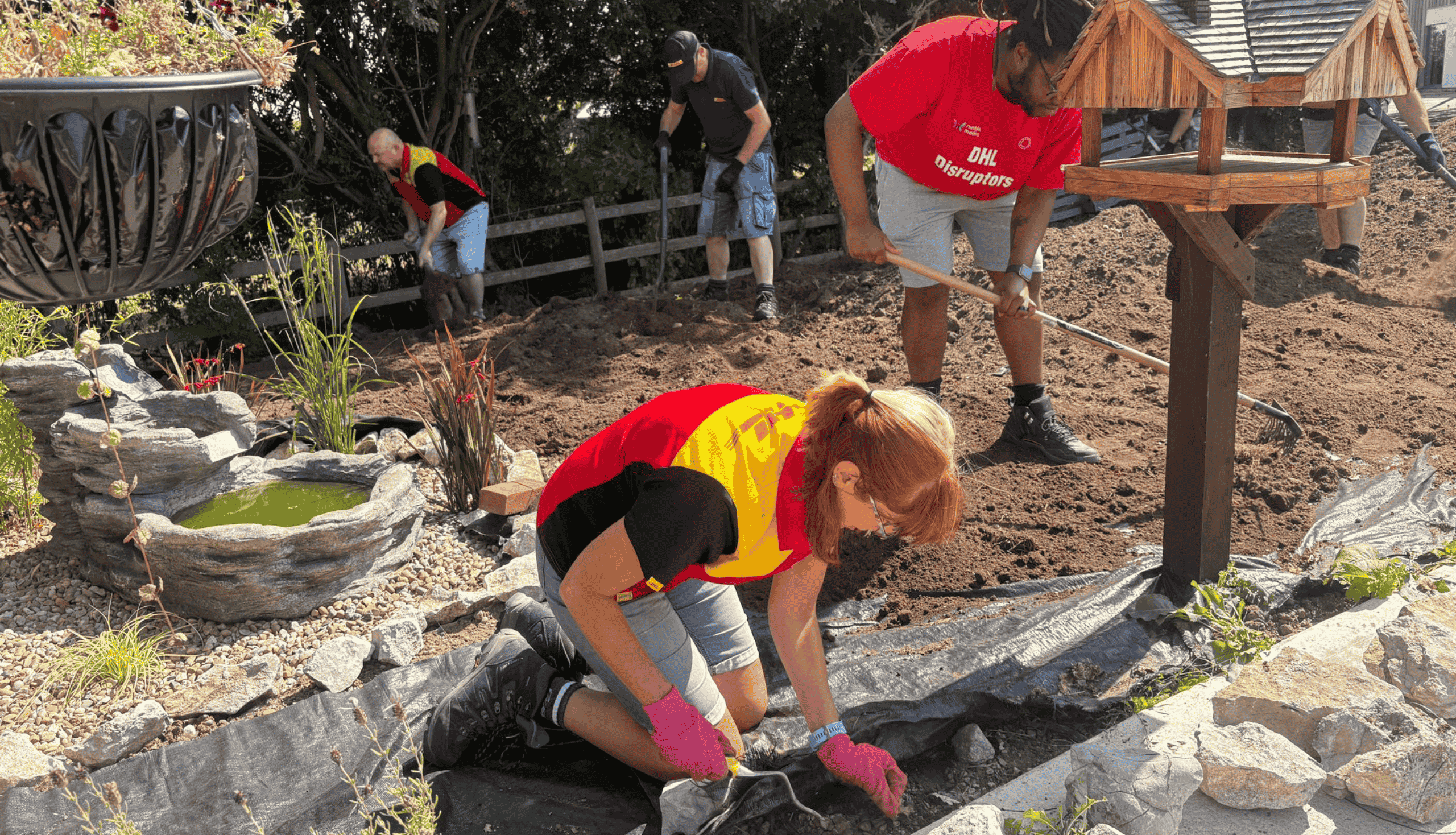 DHL Employee planting plants in our garden